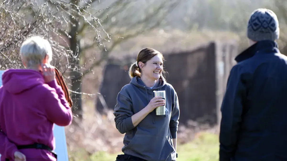 Dog owners discussing training options with a trainer